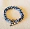 Captured Bead Chainmaille Bracelet by Janette Bond. Chainmaille Bracelet using variation of Round Maille to capture bead inside work.